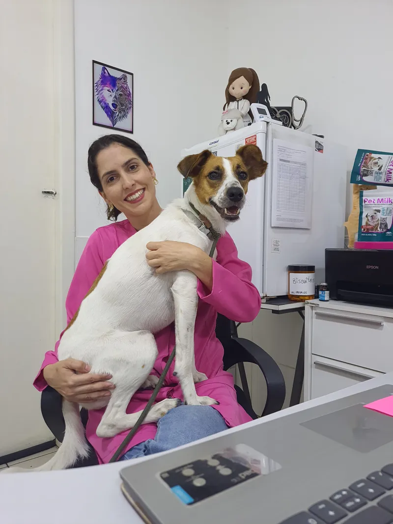 Dra. Alinne com um cão no consultório